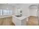 Modern kitchen featuring stainless steel appliances, double islands, and hardwood floors at 2221 Loggerhead Rd, Las Vegas, NV 89117