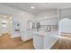 Bright kitchen featuring modern appliances, double islands, wood floors, and stylish fixtures at 2221 Loggerhead Rd, Las Vegas, NV 89117