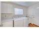 Laundry room featuring washer, dryer, cabinets, and a utility sink at 2221 Loggerhead Rd, Las Vegas, NV 89117