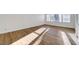 Empty living room featuring light wood flooring and large windows at 2221 Loggerhead Rd, Las Vegas, NV 89117