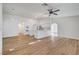 Inviting living room featuring wood floors, a ceiling fan, and an open layout to the kitchen at 2221 Loggerhead Rd, Las Vegas, NV 89117