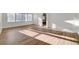Bright living room featuring wood-look flooring, multiple windows, and neutral paint, a blank canvas for personalization at 2221 Loggerhead Rd, Las Vegas, NV 89117