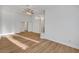 Bright living room with hardwood floors, neutral paint, and access to other rooms at 2221 Loggerhead Rd, Las Vegas, NV 89117