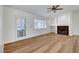 Spacious room with fireplace, door to outside, neutral walls and light wood flooring at 2221 Loggerhead Rd, Las Vegas, NV 89117