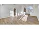 A bright living room with wood-look floors, arched doorways, and neutral paint, waiting for your personal touches at 2221 Loggerhead Rd, Las Vegas, NV 89117