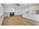 Open-concept living space with fireplace, natural light and views into kitchen at 2221 Loggerhead Rd, Las Vegas, NV 89117