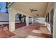 Well-lit covered patio with ceiling fans, concrete flooring, and easy access to the landscaped yard at 2221 Loggerhead Rd, Las Vegas, NV 89117