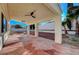 Inviting covered patio featuring ceiling fans and decorative concrete flooring with access to a landscaped yard at 2221 Loggerhead Rd, Las Vegas, NV 89117