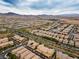 A stunning bird's eye view of a meticulously planned community near distant mountains at 2376 Via Firenze, Henderson, NV 89044