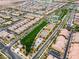 Aerial view highlighting community amenities, showcasing sports courts and common green areas amidst residential houses at 2376 Via Firenze, Henderson, NV 89044