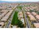 Wide aerial view of a residential area, emphasizing the neighborhood park and recreational facilities in the community at 2376 Via Firenze, Henderson, NV 89044