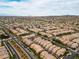 Expansive aerial view of a well-planned community with uniform houses against a scenic mountain backdrop at 2376 Via Firenze, Henderson, NV 89044