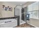 Bathroom featuring a large soaking tub and a glass enclosed shower at 2376 Via Firenze, Henderson, NV 89044
