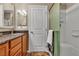 Bathroom featuring a vanity with a dark countertop, wood cabinets and a glass shower stall at 2376 Via Firenze, Henderson, NV 89044