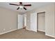 Bedroom with plush carpeting, a ceiling fan, and a closet providing ample storage space at 2376 Via Firenze, Henderson, NV 89044