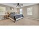 Bright bedroom with a ceiling fan, carpet, and comfortable queen sized bed at 2376 Via Firenze, Henderson, NV 89044