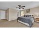 Well-lit bedroom with carpet, a queen sized bed, and a ceiling fan at 2376 Via Firenze, Henderson, NV 89044