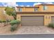 A home with a two-car garage, desert landscaping, and pavers in the driveway at 2376 Via Firenze, Henderson, NV 89044