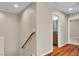 Hallway with wood floors, wood handrail, and a view to a bathroom at 2376 Via Firenze, Henderson, NV 89044