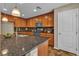 Well-lit kitchen boasts granite counters, wood cabinetry, and stainless steel appliances at 2376 Via Firenze, Henderson, NV 89044
