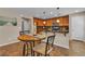 Cozy kitchen has a granite countertop island bar with a breakfast table for casual dining at 2376 Via Firenze, Henderson, NV 89044