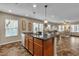 Kitchen island with stainless sink, granite countertops and wood cabinetry at 2376 Via Firenze, Henderson, NV 89044