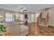 Bright living room features a ceiling fan, plush furniture, and staircase, creating a comfortable and inviting space at 2376 Via Firenze, Henderson, NV 89044