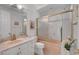 Cozy bathroom with a shower, a sink, and decorative wallpaper at 2705 Crystal Beach Dr, Las Vegas, NV 89128