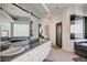 Bathroom with granite counters, double sinks, glass block window, and soaking tub at 2705 Crystal Beach Dr, Las Vegas, NV 89128