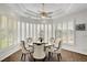 Elegant dining area featuring a tray ceiling, wood floors, and abundant natural light from surrounding windows at 2705 Crystal Beach Dr, Las Vegas, NV 89128