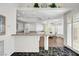 Bright, open kitchen features granite counters, white cabinets, and a seamless flow to the adjacent dining area at 2705 Crystal Beach Dr, Las Vegas, NV 89128