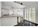Sunlit kitchen boasts granite countertops, white cabinetry, and an open layout ideal for entertaining at 2705 Crystal Beach Dr, Las Vegas, NV 89128
