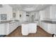 Bright kitchen with white cabinets, granite countertops, and an island with a cooktop at 2705 Crystal Beach Dr, Las Vegas, NV 89128