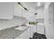 Laundry room with front-loading machines and a utility sink at 2705 Crystal Beach Dr, Las Vegas, NV 89128
