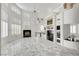 Spacious living area featuring a fireplace, mirrored bar, large windows, and sleek marble floors at 2705 Crystal Beach Dr, Las Vegas, NV 89128