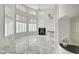 Bright and airy living room with high ceilings, fireplace, and a sleek mirrored bar at 2705 Crystal Beach Dr, Las Vegas, NV 89128
