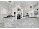 Expansive living room boasts high ceilings, a fireplace, stylish mirrored bar, and elegant marble flooring at 2705 Crystal Beach Dr, Las Vegas, NV 89128