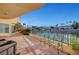 Spacious lakefront patio with wrought iron seating and views of the lake and palm trees at 2705 Crystal Beach Dr, Las Vegas, NV 89128
