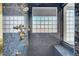Elegant walk-in shower featuring glass block window and rainfall shower head at 2705 Crystal Beach Dr, Las Vegas, NV 89128