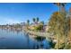 Picturesque waterfront property with lush landscaping and serene lake views with homes nestled around the water at 2705 Crystal Beach Dr, Las Vegas, NV 89128