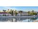 Waterfront homes with palm trees offering serene lake views at 2705 Crystal Beach Dr, Las Vegas, NV 89128