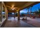 Covered patio overlooks a backyard oasis with a pool, spa, and tropical landscaping at 2764 Kilwinning Dr, Henderson, NV 89044