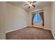 This bedroom offers neutral carpeting, a ceiling fan and a window with curtains at 2764 Kilwinning Dr, Henderson, NV 89044
