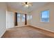 This bedroom is spacious with a ceiling fan, carpet, and multiple windows for natural light at 2764 Kilwinning Dr, Henderson, NV 89044