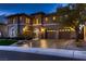 Stunning two-story home featuring a three-car garage, stone accents, and well-manicured landscaping at 2764 Kilwinning Dr, Henderson, NV 89044