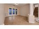Bright living area with backyard access, neutral walls, tile floors and staircase access at 2764 Kilwinning Dr, Henderson, NV 89044