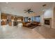 Open-concept living room with fireplace, tile flooring, and seamless flow into the kitchen at 2764 Kilwinning Dr, Henderson, NV 89044