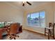 Bright office featuring carpet, a window with backyard views, a desk and a chair at 2764 Kilwinning Dr, Henderson, NV 89044