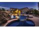 Beautiful backyard pool with hot tub, rock features, and tiki bar create an outdoor oasis at 2764 Kilwinning Dr, Henderson, NV 89044