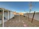 The backyard offers a gravel landscape design, with a pathway, and a minimalist aesthetic at 2914 Luminous Ct, North Las Vegas, NV 89032